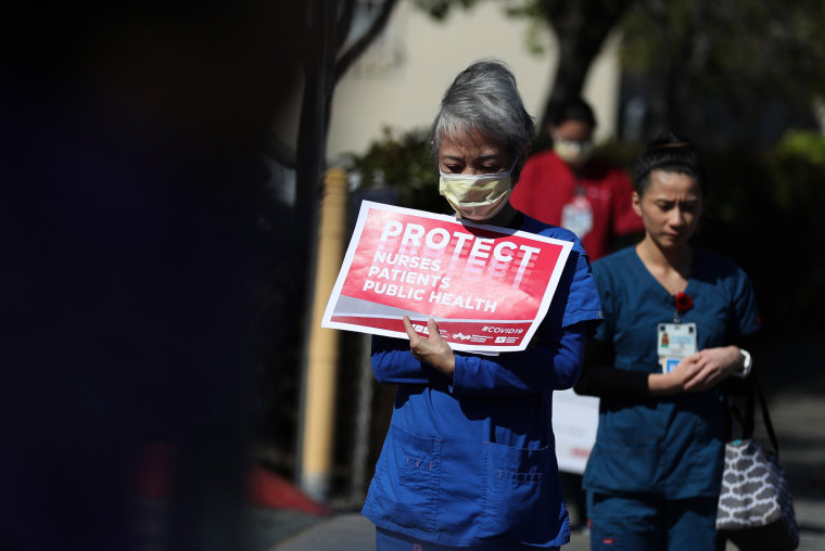 Image: Health care workers protest to demand better working conditions and proper personal protective equipment outside a hospital in Alameda