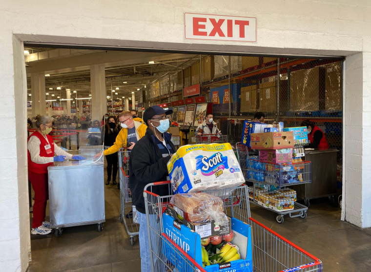 Image: Shoppers exit a Costco store in Arlington, Va.