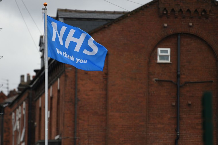 Image: A flag displaying support for the National Health Service (NHS) flutters in Ashton-under-Lyne in Greater Manchester