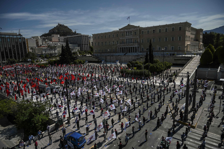 Image: Members of the Greek Labour Union (PAME), wearing protective masks and respecting the social distances against the spread of the novel coronavirus, COVID-19,  protest in front of the Greek Parliament during the Labour Day demonstration in Athens