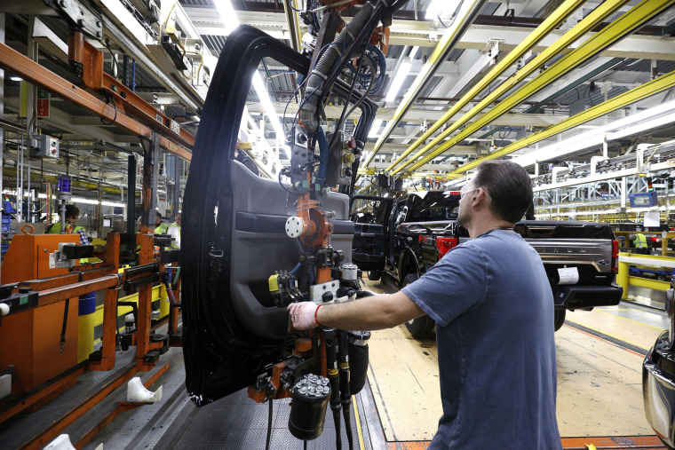 Image: A Ford Motor Company workers works on a Ford F150 truck on the assembly line at the Ford Dearborn Truck Plant