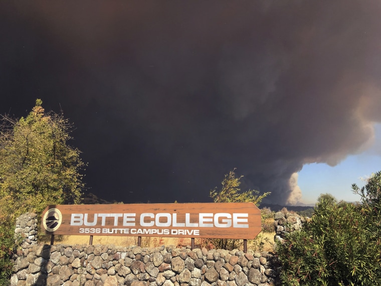 Smoke from the Camp Fire darkens the sky above the Butte College sign in Oroville, Calif., on Nov. 8, 2018.