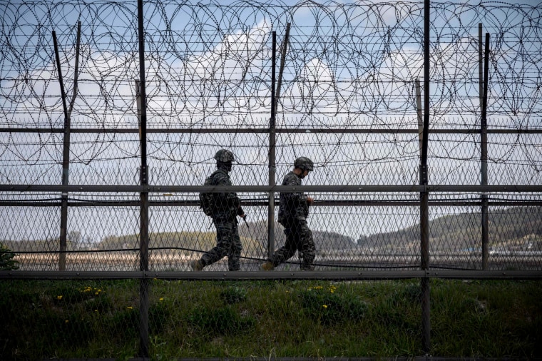 Image: South Korean soldiers patrol the barbed wire fence of the Demilitarized Zone separating North and South Korea on April 23, 2020.