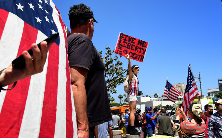 Image: Demonstrators protest stay-at-home orders outside of Los Angeles City Hall on May 1, 2020.