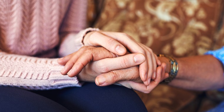 Closeup of women's hands clasped together