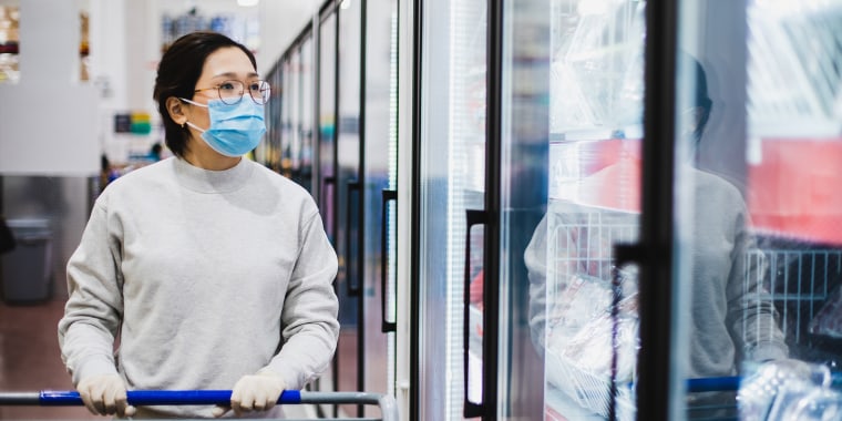 Asian female wearing a face mask shopping at the supermarket