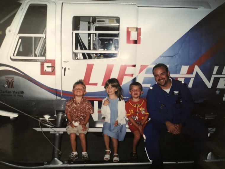For a time, Kraus worked as a flight nurse on a helicopter. Here, he poses with the children of family friends in 2002.
