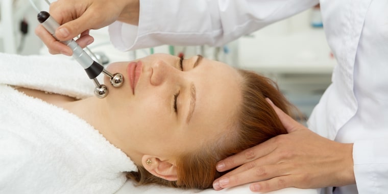Beautiful woman receiving facial treatment