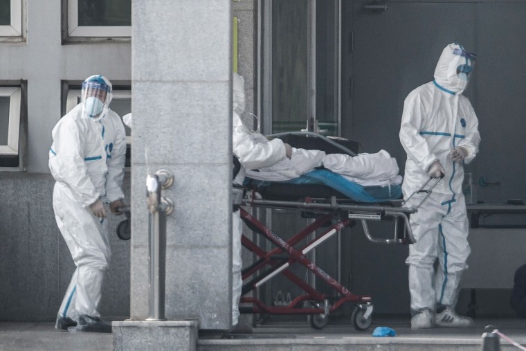 Image: Medical staff members carry a patient into the Jinyintan hospital, where patients infected by a mysterious SARS-like virus are being treated, in Wuhan in China's central Hubei province