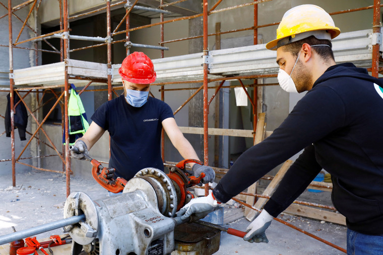 Image: Workers at a construction site 