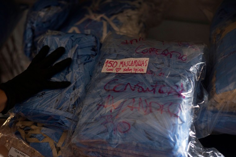 Image: Chilean Cristian Jara, creator of the iniciative "Mascarillas Gratis" (Free Masks), shows packages containing hundreds of face makes in Santiago