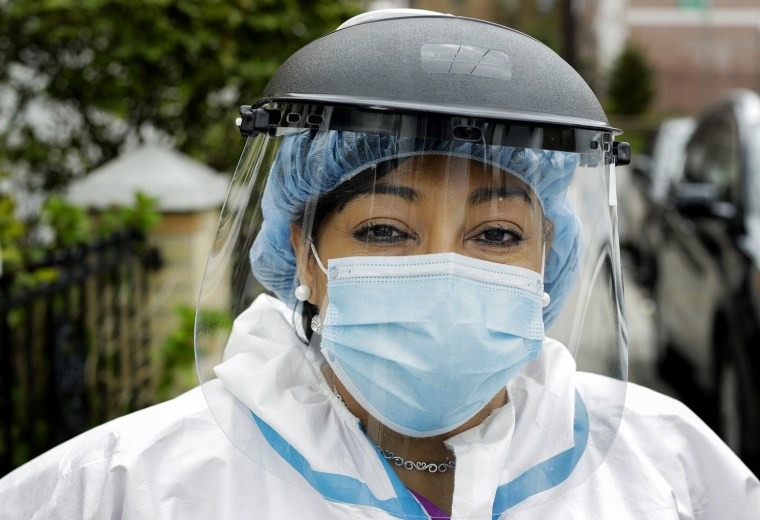 Image: Linda Silva, a nurse's assistant who tested positive for COVID-19, returns to work after recovering in Queens, N.Y., on April 30, 2020.