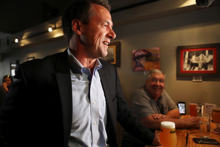Montana Governor Steve Bullock talks to patrons of the Ten Mile Brewery as he launches 2020 U.S. presidential campaign in Helena, Montana