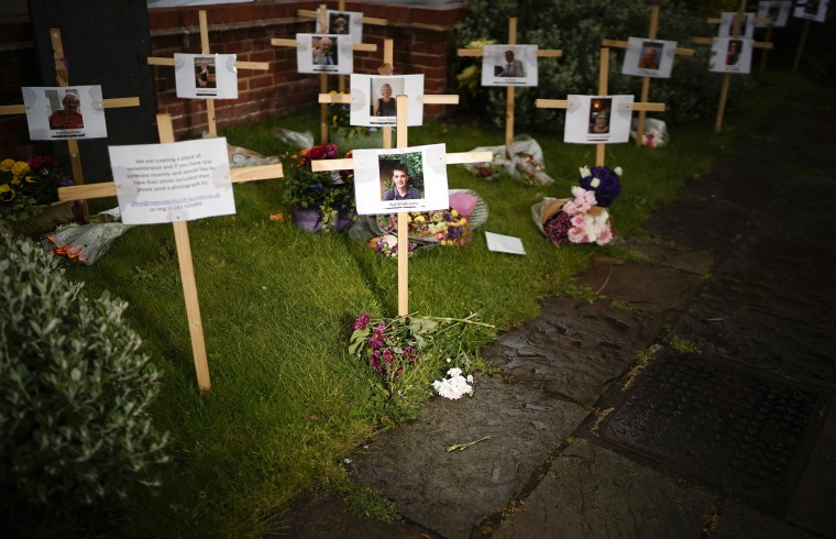 Image: Photographs and memorials for those who died during the lockdown sit outside Riverside Church on April 30, 2020 in Burton-on-Trent, England.