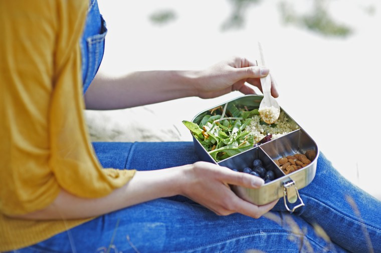 Image: Woman eating healthy lunch outdoors, close up.
