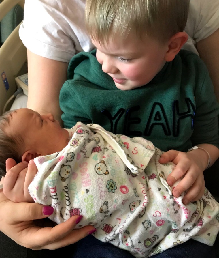 Atticus Svoboda holds his sister, Violet. "It's been hard splitting my time and making sure that's he's okay with the new baby and not being able to go and do anything," Leann Svoboda said.