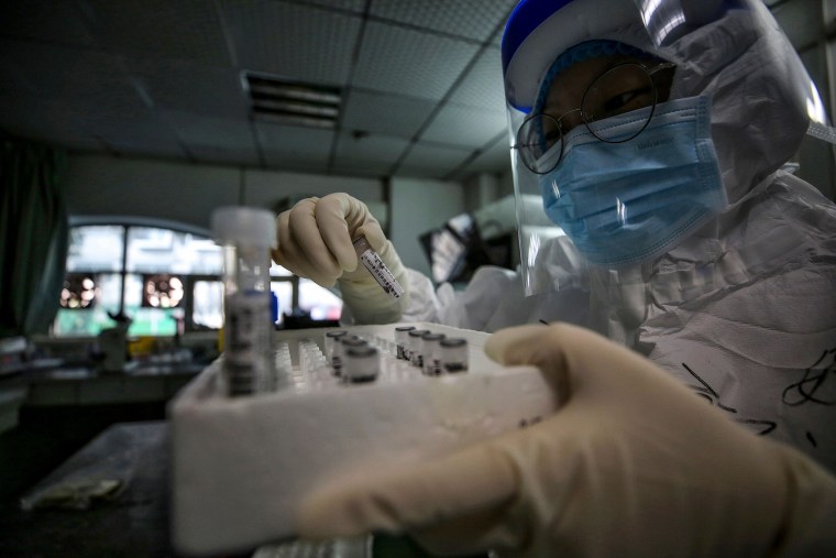Image: A medical staff member holds samples from patients infected by COVID-19 in Wuhan, China,