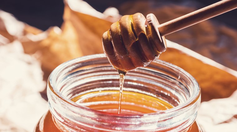 Bio Bee honey with wooden dipper - Honey's dessert concept image