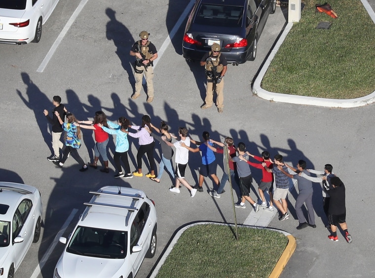 Image: Students are brought out of the Marjory Stoneman Douglas High School