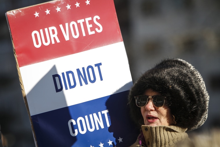 A protester at a rally at the Michigan State Capitol before the state electoral college met to cast their votes