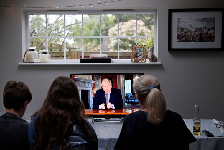 Image: A family watch Britain's Prime Minister Boris Johnson