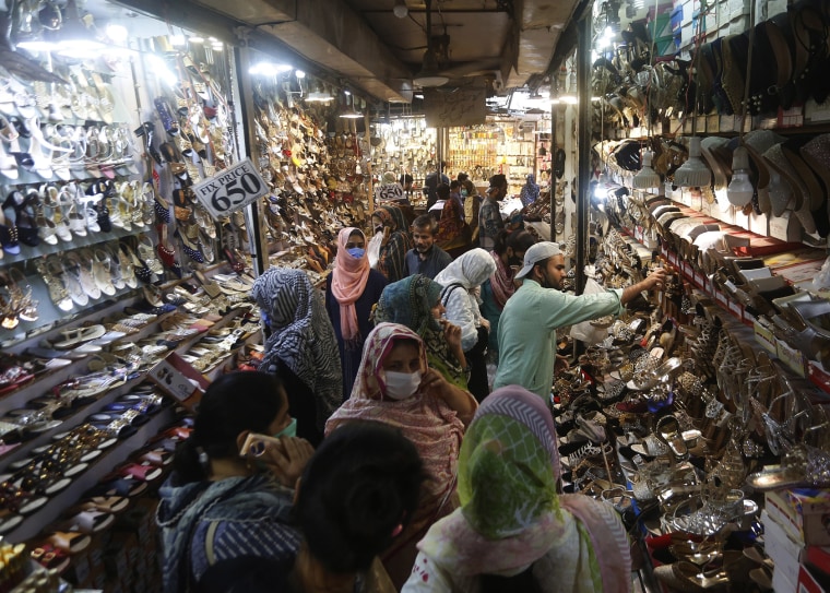 Image: People visit a market after the government relaxed a weeks-long lockdown in Lahore, Pakistan on Monday.