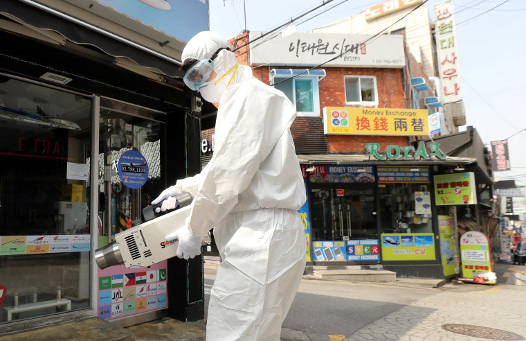 Image: A quarantine worker sprays disinfectants at night spots of Itaewon neighborhood, following the coronavirus disease (COVID-19) outbreak, in Seoul