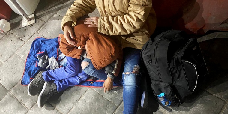Image: A migrant child sleeps while waiting overnight at the Paso Del Norte Bridge.