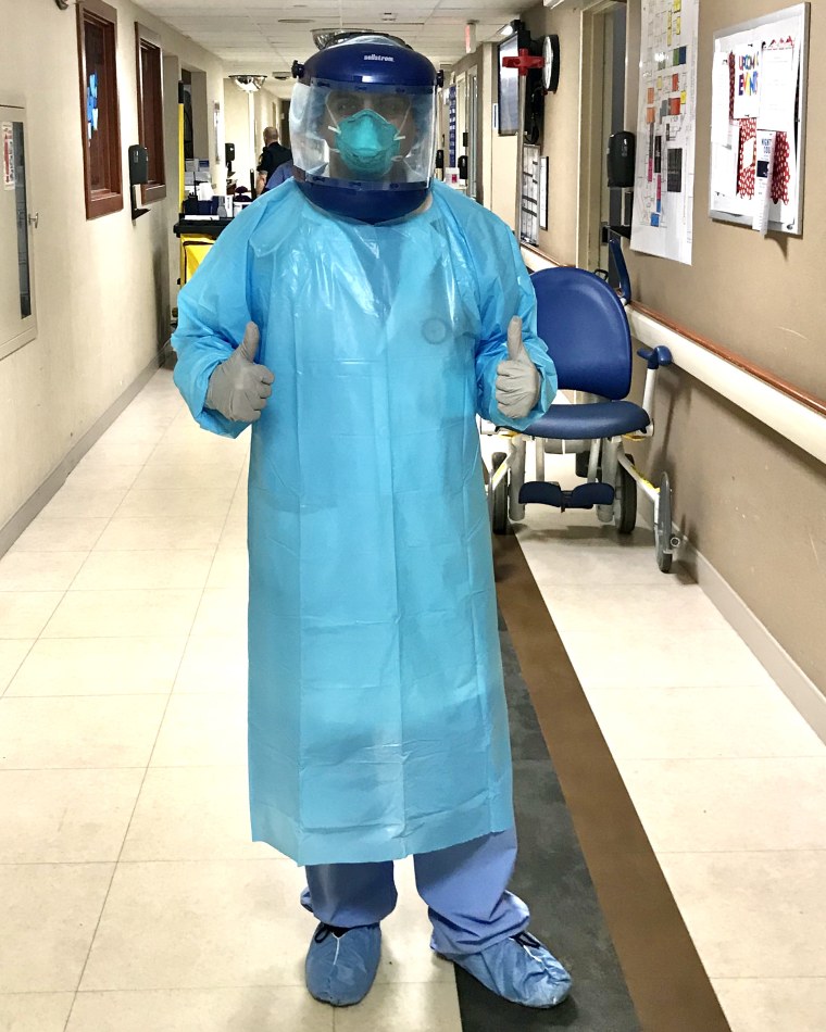 Dr. Parth Mehta, an immigrant physician in Illinois, dresses in PPE before seeing a COVID-19 patient.