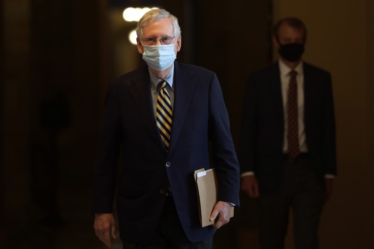 Image: Senate Majority Leader Sen. Mitch McConnell (R-KY) wears a mask as he walks through a hallway at the U.S. Capitol