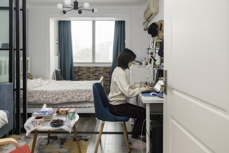 Image: An employee works from her home in Shanghai