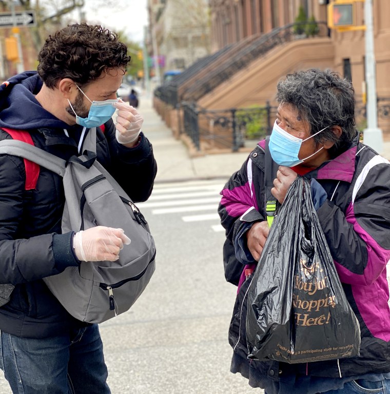 Jayson Conner hands out a backpack. 