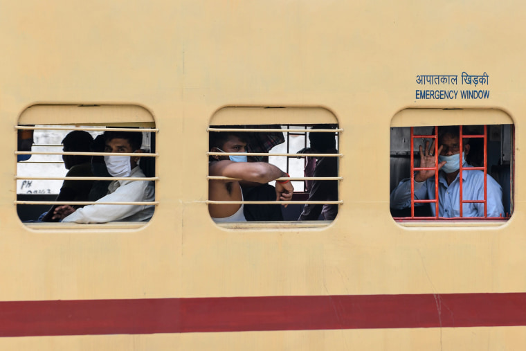 Image: Migrant workers and families head back to their hometowns on Wednesday on a special train to Uttar Pradesh after the government eased a nationwide lockdown.
