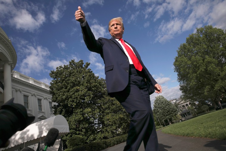 Image: President Donald Trump give a thumbs up to reporters and cameras as he heads to the Marine One helicopter to depart for a weekend at Camp David from the South Lawn of the White House