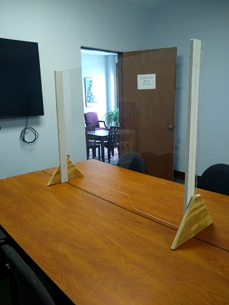 Image: A new glass barrier in the conference room where Rise-NY advocates work with non-residential clients to file family offense petitions since the local family court is closed to everything but e-filing.