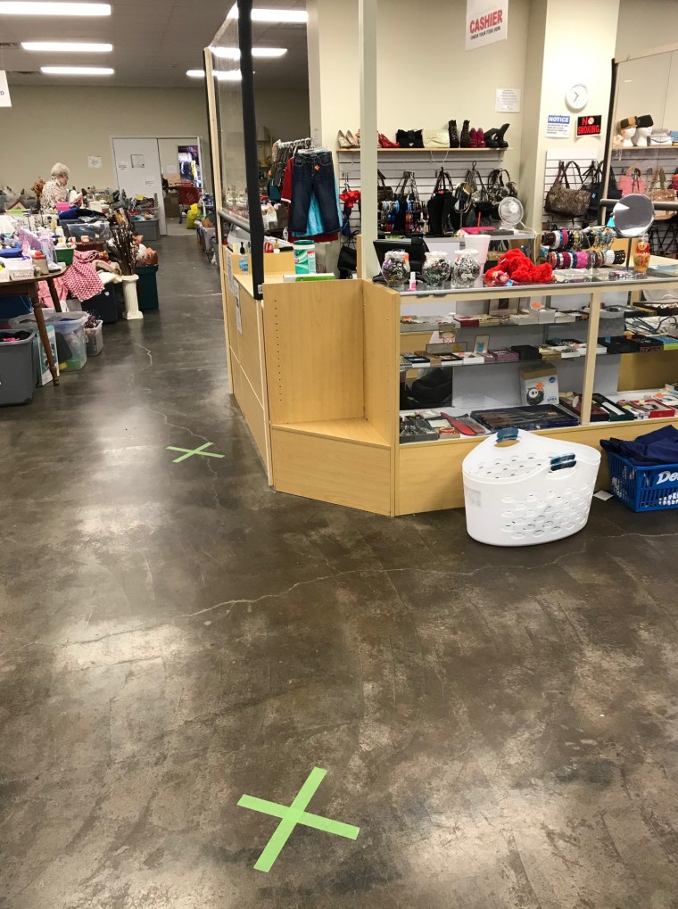 Image: Tape on the floor and plexiglass barriers in the newly reopened thrift store run by Safe House for Women of Cape Girardeau, Missouri. Before the coronavirus, the thrift store provided 30 percent of the domestic violence nonprofit's operating budget