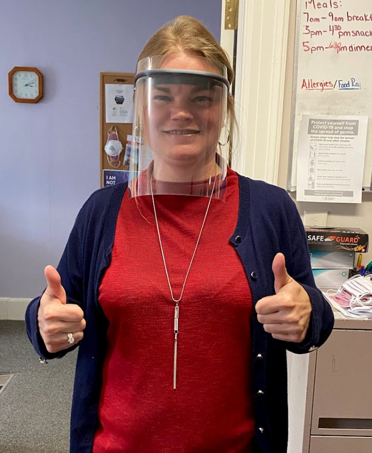 Image: April Hopkins, shelter manager for Rise-NY, with a face shield made by a shelter maintenance worker.