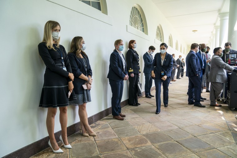 Image: White House staff and guests, wearing face masks, wait for a news conference with President Donald Trump about the coronavirus in the Rose Garden of the White House in Washington, Monday, May 11, 2020. (Doug Mills/The New York Times)