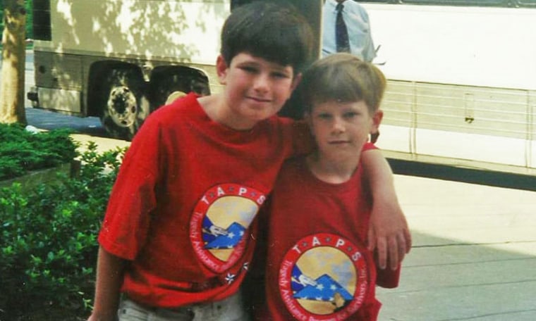 Nathaniel Lee, left, and his younger brother Sam Lee, right, are pictured as camp kids at their first TAPS Good Grief Camp in May 1999. The boys lost their father, U.S. Army Capt. Donald Lee, in a helicopter crash in December 1997.