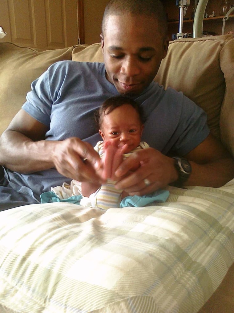 Shortly before his death in Afghanistan at age 26, Demetrius Frison snuggled and played with his baby boy, Chris Frison.
