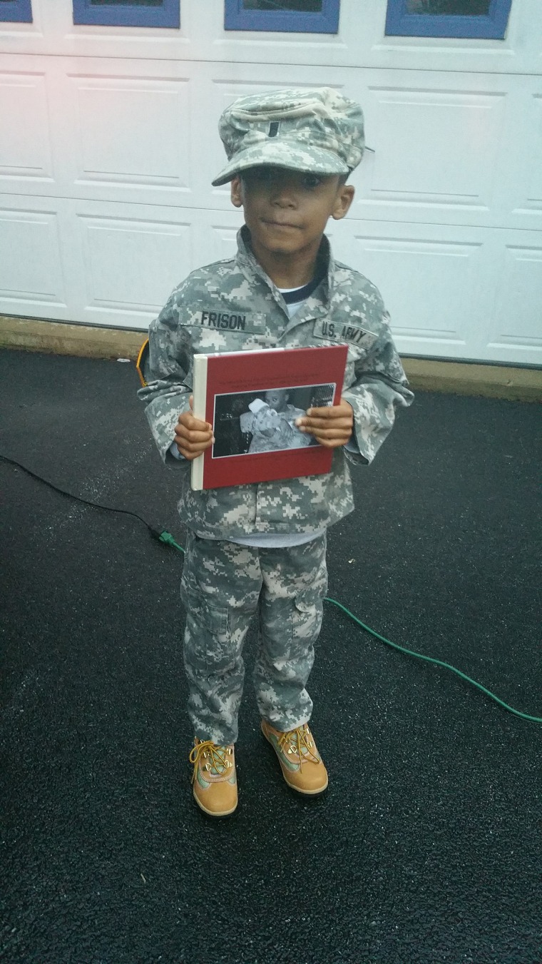 Chris Frison holds a photo of his dad, Demetrius Frison, a first lieutenant in the U.S. Army who died in an explosion in Afghanistan in 2011 when Chris was a baby.