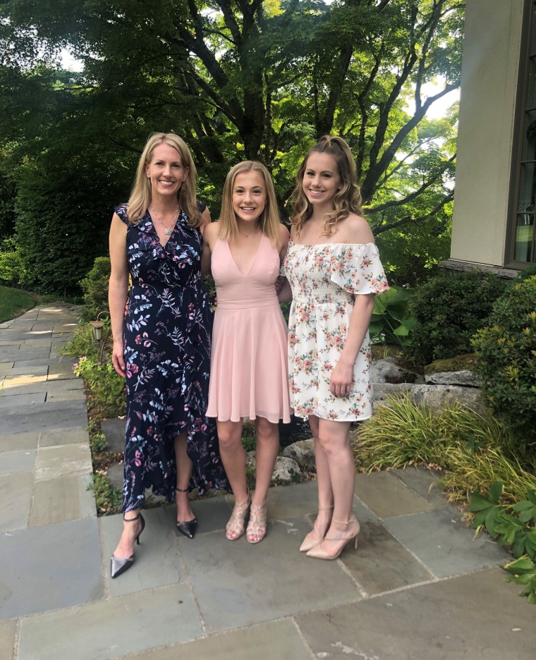 Mezulis with daughters Anna and Elsie at Elsie's 8th grade graduation.