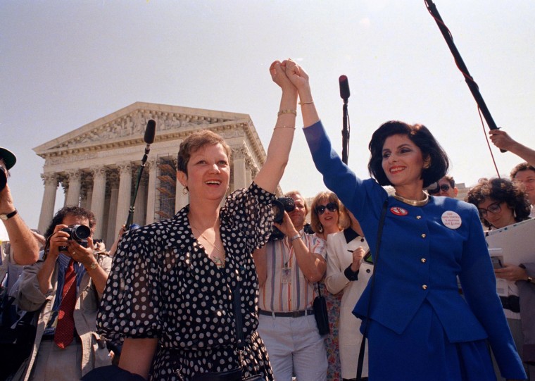 Image: Norma McCorvey, also known as \"Jane Roe\" in the 1973 court case Roe v. Wade, holds hands with her attorney, Gloria Allred, as they leave the Supreme Court in 1989.
