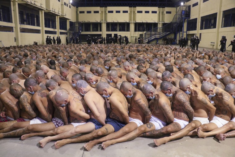 Image: Inmates wearing face masks are lined up during a security sweep at the Izalco prison in San Salvador, El Salvador.