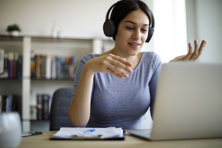 Image: Young woman having video call on laptop computer at home