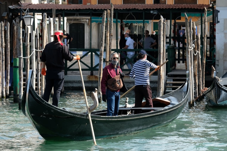 Image: Gondoliers resume their service on the Grand Canal as Italy eases some more of the lockdown measures put in place during the coronavirus disease (COVID-19) outbreak, in Venice