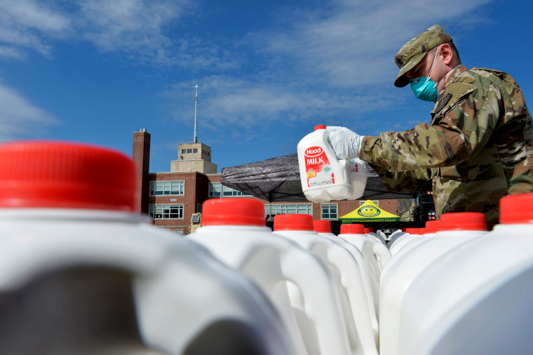 Image: Massachusetts National Guard soldiers distribute milk to residents in need in Boston on May 7, 2020. The milk was provided by dairy farmers getting rid of excess milk after demand fell during the coronavirus outbreak.