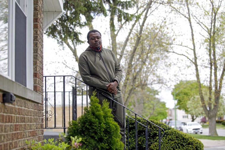 James Carter, a certified nursing assistant at Alden Lakeland nursing home, outside his home in Chicago.