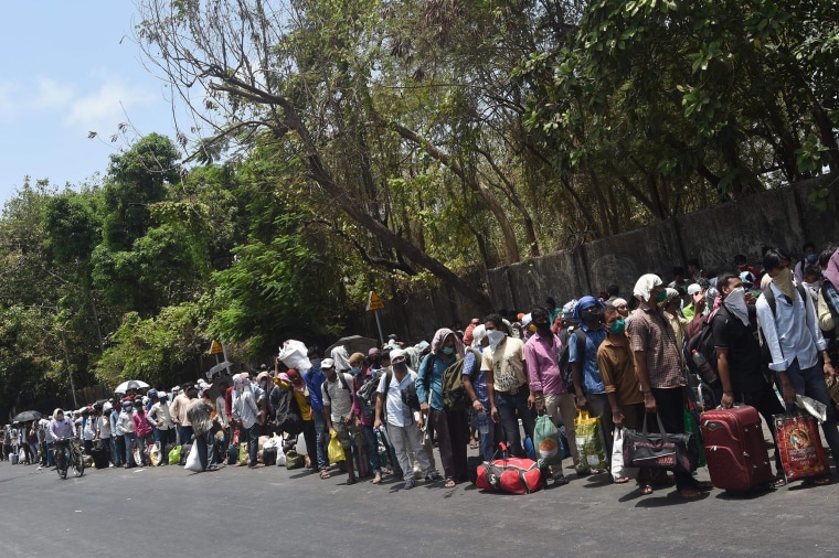 Migrant workers queue outside a railway station in Mumbai after the government eased a nationwide lockdown as a preventive measure against the coronavirus pandemic. 