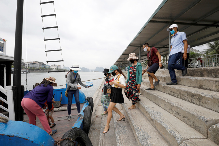 Image: Vietnamese tourists visit Ha Long Bay, Vietnam on Tuesday after the government eased the lockdown.
